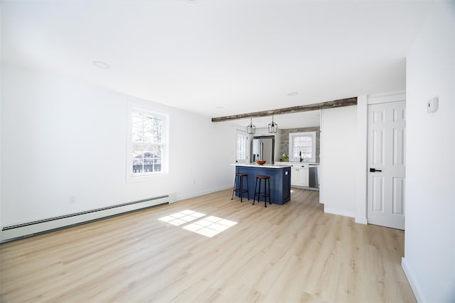 3 Holt Rd, Red Hook, NY 12571 - unfurnished living room with a baseboard radiator, baseboards, and light wood-type flooring