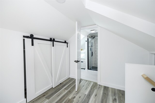 3 Holt Rd, Red Hook, NY 12571 - additional living space with light wood-style floors, a barn door, and vaulted ceiling