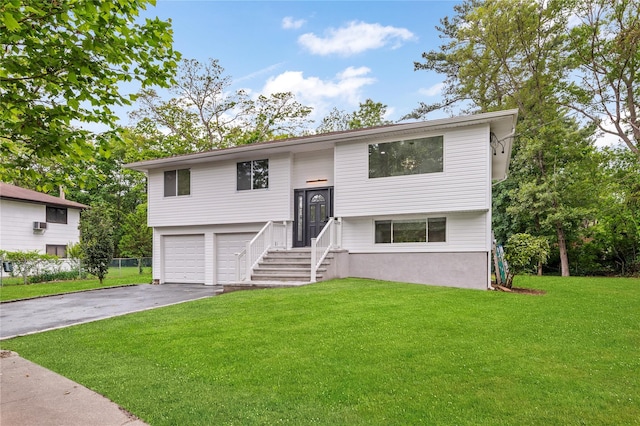 155 Brooklyn Ave, Huntington, NY 11743 - split foyer home featuring a front lawn, an attached garage, and driveway