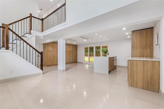 155 Brooklyn Ave, Huntington, NY 11743 - unfurnished living room featuring stairway, recessed lighting, light tile patterned floors, and a sink
