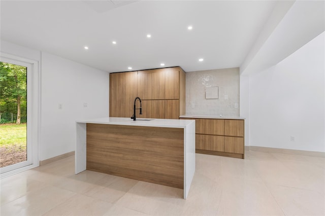 155 Brooklyn Ave, Huntington, NY 11743 - kitchen featuring modern cabinets, a sink, brown cabinets, recessed lighting, and light countertops