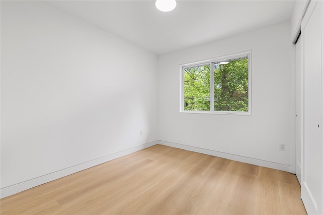 155 Brooklyn Ave, Huntington, NY 11743 - unfurnished bedroom with wood finished floors, baseboards, and a closet