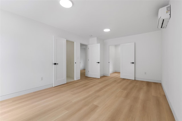 155 Brooklyn Ave, Huntington, NY 11743 - unfurnished bedroom with a wall unit AC, baseboards, light wood-style floors, and recessed lighting