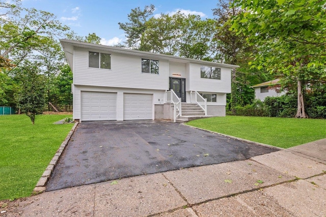 155 Brooklyn Ave, Huntington, NY 11743 - bi-level home with asphalt driveway, an attached garage, and a front lawn