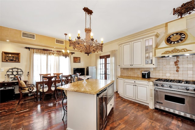 186-31 Radnor Rd, Jamaica Estates, NY 11432 - kitchen featuring premium range, dark wood-type flooring, a chandelier, a kitchen bar, and glass insert cabinets