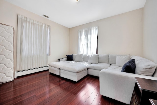 186-31 Radnor Rd, Jamaica Estates, NY 11432 - living room featuring baseboard heating and dark wood-type flooring