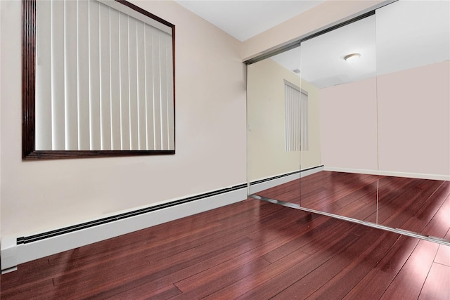 186-31 Radnor Rd, Jamaica Estates, NY 11432 - unfurnished bedroom featuring a baseboard heating unit, hardwood / wood-style floors, and a closet