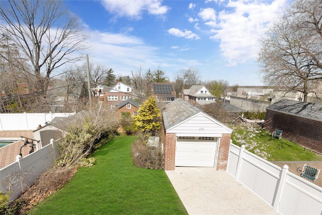 186-31 Radnor Rd, Jamaica Estates, NY 11432 - view of yard with a detached garage, driveway, an outdoor structure, and a residential view