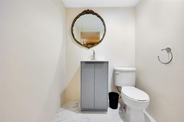 186-31 Radnor Rd, Jamaica Estates, NY 11432 - bathroom with marble look tile flooring, toilet, and a sink