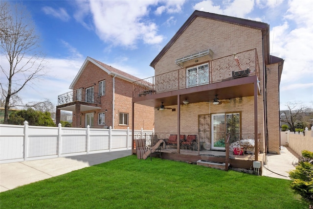 186-31 Radnor Rd, Jamaica Estates, NY 11432 - back of property with a ceiling fan, a balcony, brick siding, and a patio