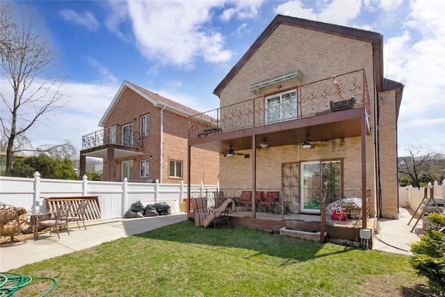 186-31 Radnor Rd, Jamaica Estates, NY 11432 - back of property with a ceiling fan, brick siding, a balcony, and a patio