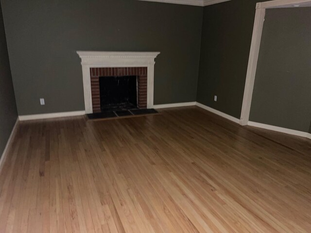 7 Beaver Dr, Locust Valley, NY 11560 - unfurnished living room with a fireplace, wood finished floors, and baseboards