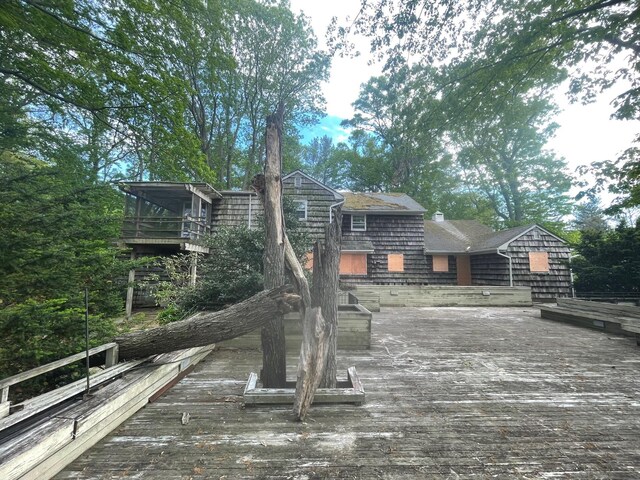 7 Beaver Dr, Locust Valley, NY 11560 - rear view of house featuring a wooden deck, a shingled roof, and a chimney