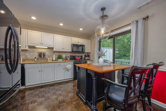 71 Frank Ct, Monroe, NY 10950 - kitchen featuring black appliances, white cabinets, backsplash, hanging light fixtures, and light stone countertops