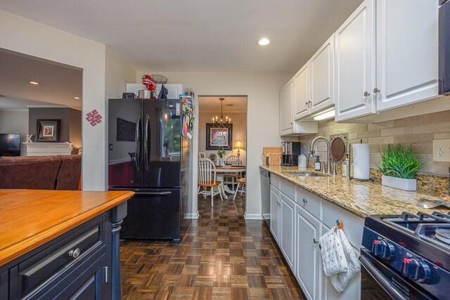 71 Frank Ct, Monroe, NY 10950 - kitchen featuring freestanding refrigerator, a chandelier, white cabinets, backsplash, and recessed lighting