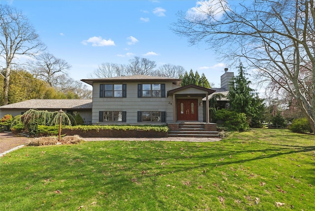 24 Brushwood Ct, East Islip, NY 11730 - split level home featuring a chimney and a front lawn