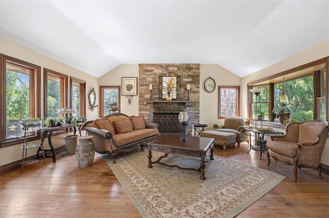 24 Brushwood Ct, East Islip, NY 11730 - living room with vaulted ceiling, a fireplace, and wood finished floors