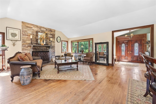 24 Brushwood Ct, East Islip, NY 11730 - living room featuring vaulted ceiling, wood finished floors, and a fireplace