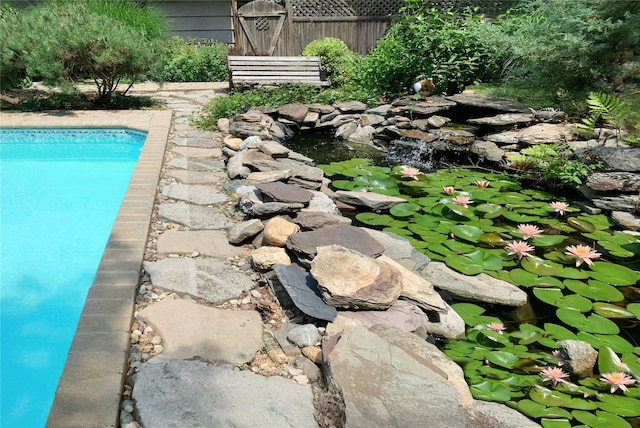 24 Brushwood Ct, East Islip, NY 11730 - view of swimming pool with a garden pond