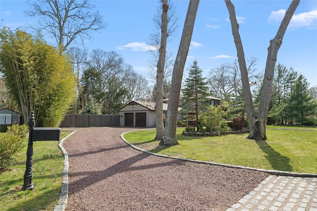 24 Brushwood Ct, East Islip, NY 11730 - view of front of home with dirt driveway, an outbuilding, and a detached garage