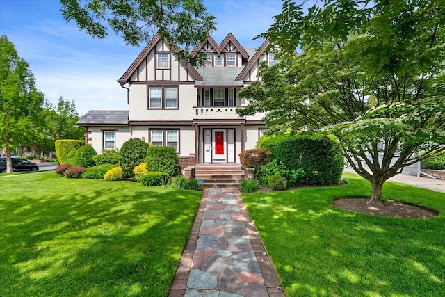 33-82 159th St, Flushing, NY 11358 - tudor-style house with stucco siding, a front yard, and brick siding