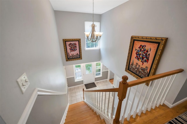 7 Ellbridge Ct, South Setauket, NY 11720 - stairs featuring a chandelier, baseboards, and wood finished floors
