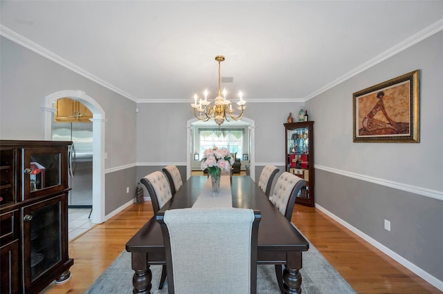 7 Ellbridge Ct, South Setauket, NY 11720 - dining space featuring a chandelier, light wood-style floors, ornamental molding, and baseboards