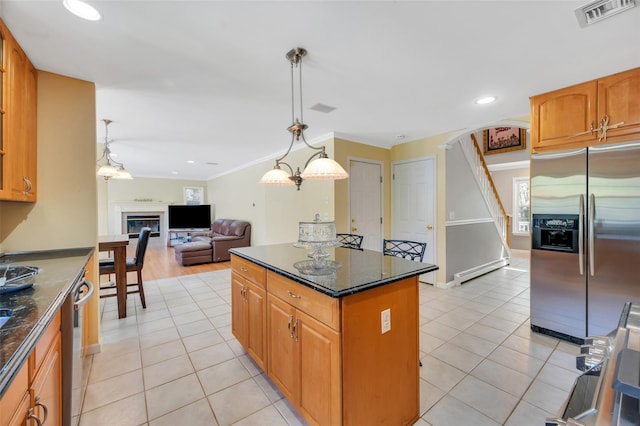 7 Ellbridge Ct, South Setauket, NY 11720 - kitchen featuring appliances with stainless steel finishes, baseboard heating, light tile patterned floors, a glass covered fireplace, and recessed lighting