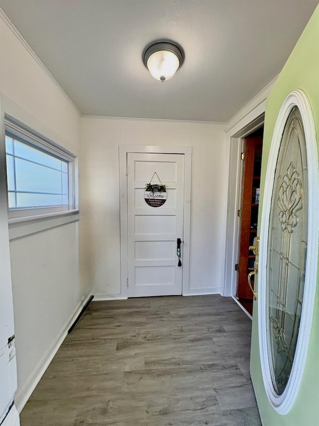 foyer entrance with wood finished floors and baseboards