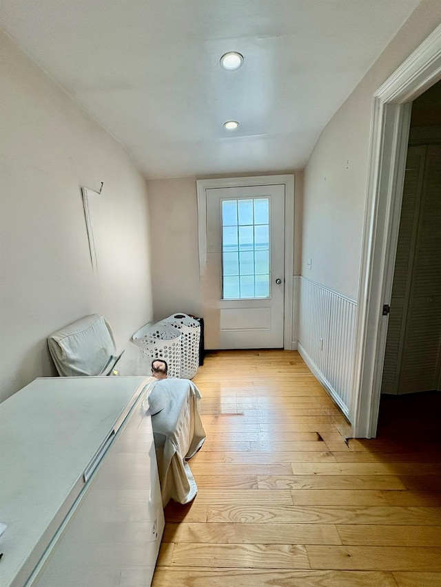 laundry room with light wood-type flooring, recessed lighting, and wainscoting
