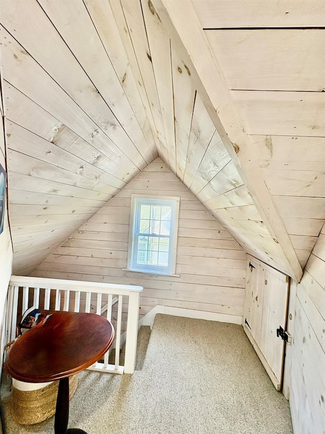 additional living space with wooden walls, lofted ceiling, wood ceiling, and light carpet
