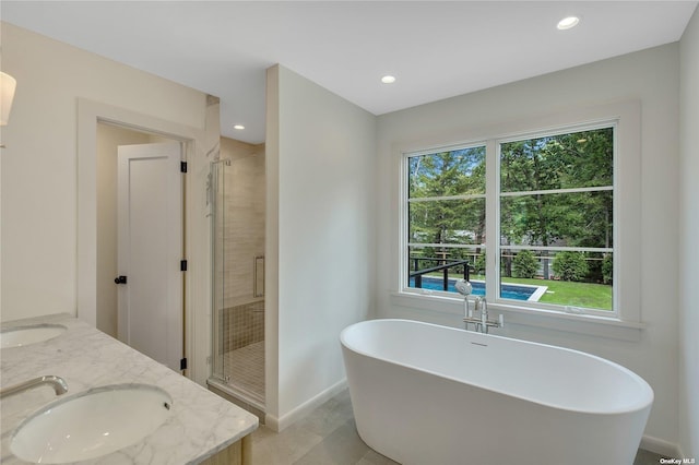 985 Track Ave, Cutchogue, NY 11935 - full bath with a shower stall, a freestanding bath, baseboards, recessed lighting, and double vanity