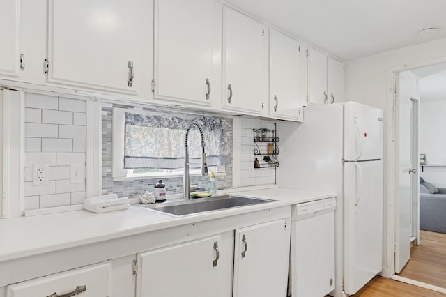 8 N Railroad Ave, Jamesport, NY 11901 - kitchen featuring white dishwasher, a sink, white cabinets, backsplash, and light countertops