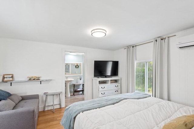 8 N Railroad Ave, Jamesport, NY 11901 - bedroom featuring wood finished floors, an AC wall unit, and baseboards