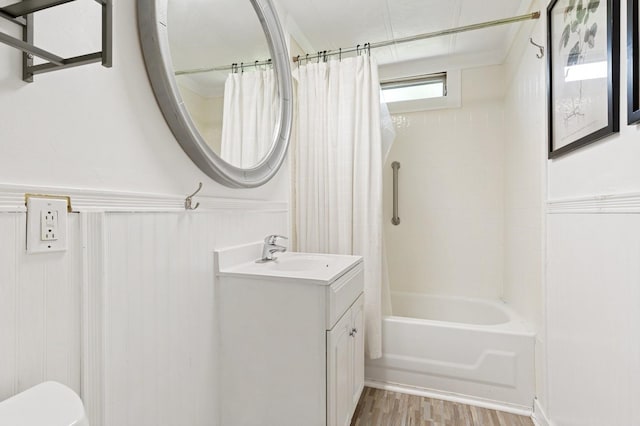 8 N Railroad Ave, Jamesport, NY 11901 - full bath featuring vanity, wainscoting, shower / bath combo, wood finished floors, and toilet