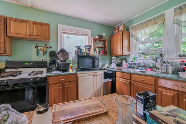 24 Park St, Kingston, NY 12401 - kitchen featuring black appliances, a sink, and brown cabinetry