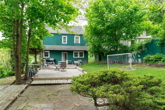 24 Park St, Kingston, NY 12401 - back of property with a wooden deck, outdoor dining space, and roof with shingles