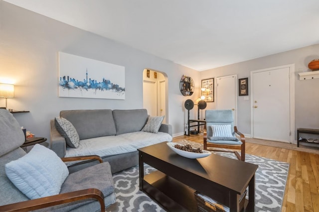 70-08 261th St Unit A1, Glen Oaks, NY 11004 - living room featuring arched walkways, light wood-type flooring, and baseboards