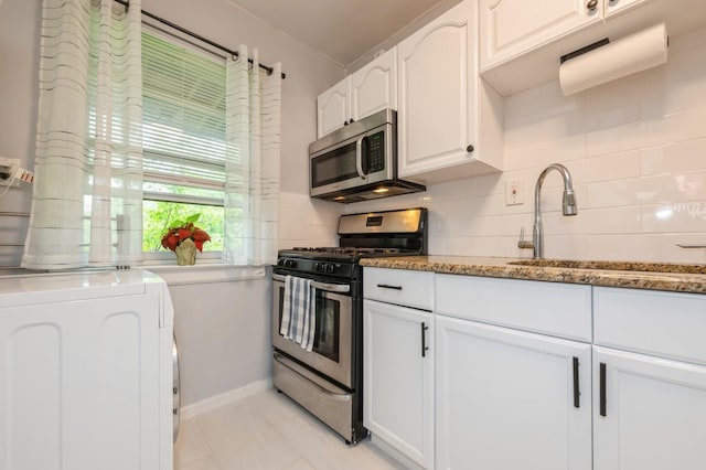 70-08 261th St Unit A1, Glen Oaks, NY 11004 - kitchen featuring appliances with stainless steel finishes, washer / clothes dryer, tasteful backsplash, and white cabinetry