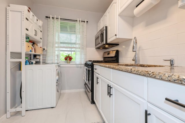 70-08 261th St Unit A1, Glen Oaks, NY 11004 - kitchen featuring stainless steel appliances, washer / clothes dryer, tasteful backsplash, and a sink