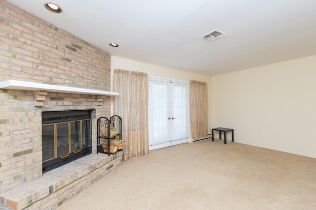 133 Revere Dr, Sayville, NY 11782 - living area featuring a brick fireplace, carpet flooring, french doors, and recessed lighting