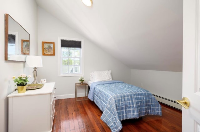 bedroom with a baseboard heating unit, lofted ceiling, dark wood finished floors, and baseboards