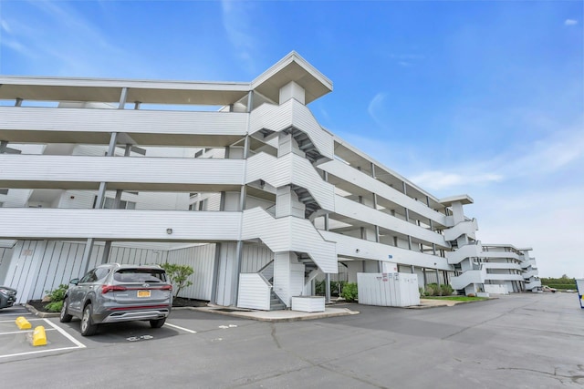 259 Dune Rd Unit 128, Westhampton Beach, NY 11978 - view of building exterior with a parking lot