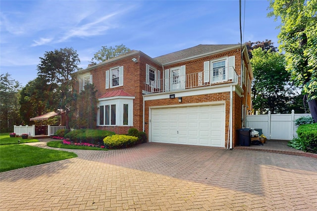 202 Broadway, Lawrence, NY 11559 - view of front of home with brick siding, a balcony, a garage, and decorative driveway