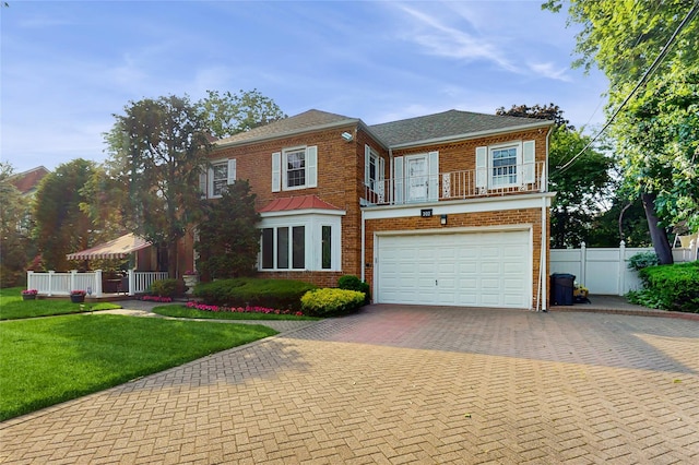 202 Broadway, Lawrence, NY 11559 - view of front of home featuring decorative driveway, brick siding, and an attached garage