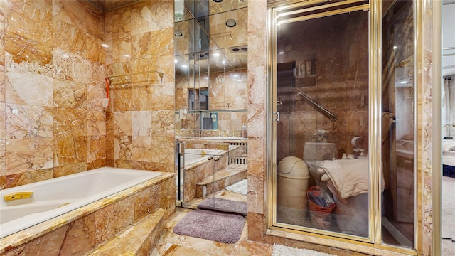 202 Broadway, Lawrence, NY 11559 - bathroom featuring a garden tub, tile walls, and a stall shower