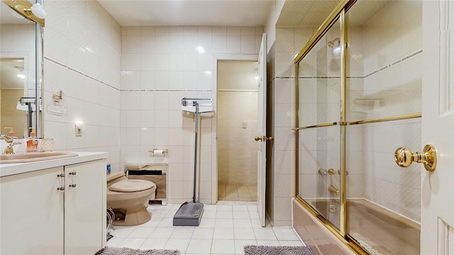 202 Broadway, Lawrence, NY 11559 - full bathroom featuring tile walls, tile patterned floors, vanity, and combined bath / shower with glass door