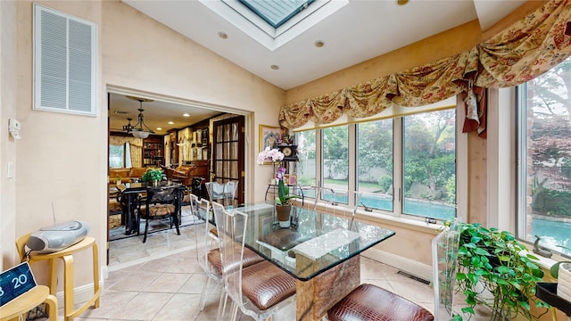 202 Broadway, Lawrence, NY 11559 - dining space featuring vaulted ceiling, light tile patterned flooring, recessed lighting, and a skylight