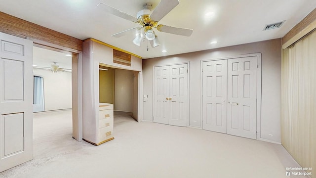 202 Broadway, Lawrence, NY 11559 - unfurnished bedroom with light carpet, recessed lighting, two closets, and ceiling fan