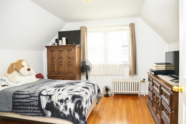 118-37 180th St, Jamaica, NY 11434 - bedroom with radiator heating unit, lofted ceiling, and light wood finished floors